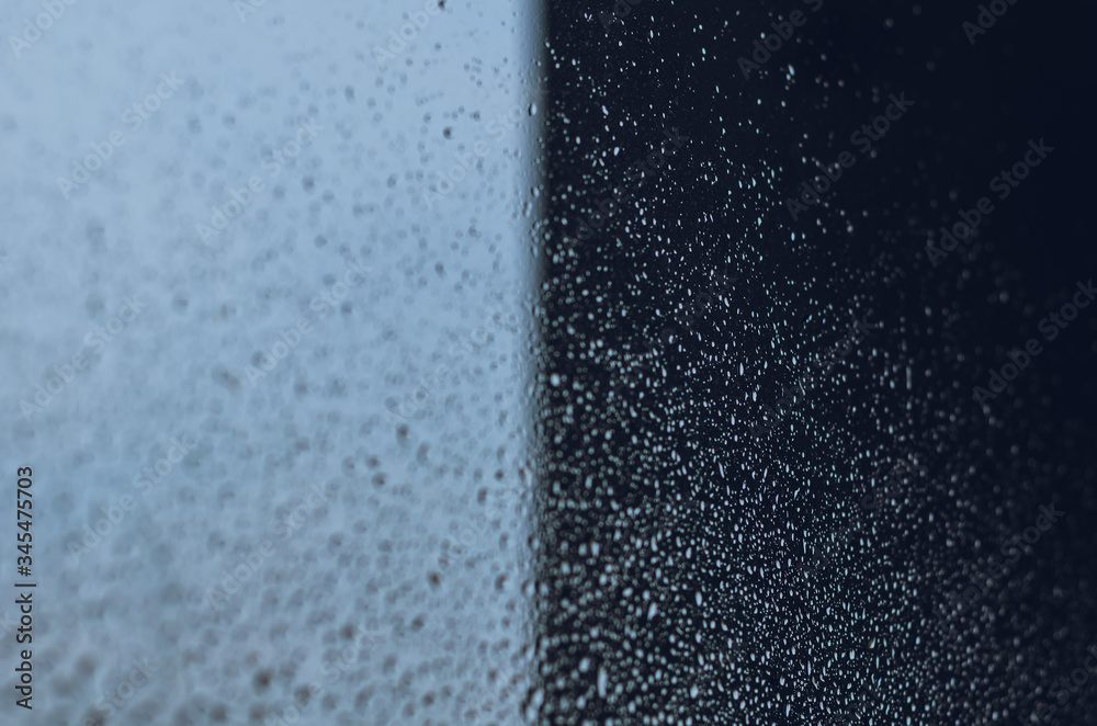 Wall mural blurred and focus of rain drop on glass window with dark side of the buiiding in monsoon season for 