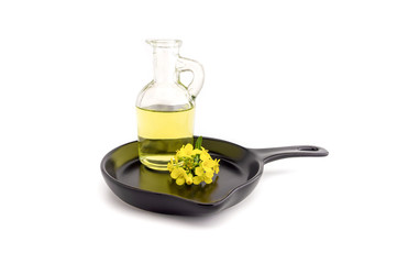 Yellow mustard flowers with decanter of oil