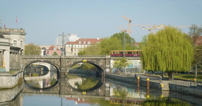 Berlin Morning Scnenery with Train on Bridge with Reflection in Water