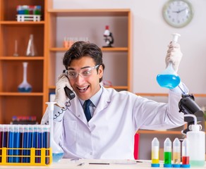 Young handsome biochemist working in the lab