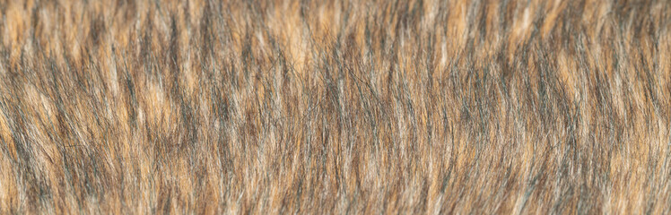 Close-up of a fluffy dark brown faux fur fabric with a background texture.