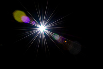 Flare light. Lens sunlight flash effect on black background. Sun shine ray star spot glow. Easy to add as overlay or screen filter over photos