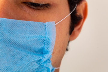 Close up blue medical face mask, suggested equipment to prevent contagion from coronavirus also called covid 19