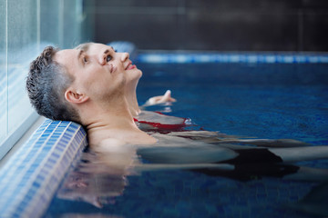 Man and woman leisure in the pool.