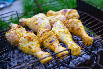 charcoal grilled chicken legs, cooking meat on the grill
