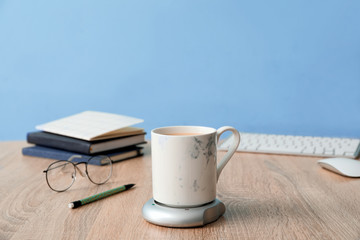 Cup of coffee with heater on table