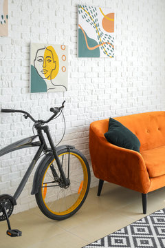 Interior of modern living room with comfortable sofa and bicycle