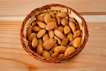 Almonds nuts shot large on a wooden background. Background for healthy eating and vegetarianism.