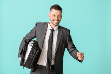 Businessman with toilet paper in bag on color background. Concept of coronavirus epidemic