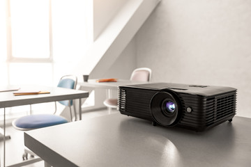 Video projector on table in conference hall
