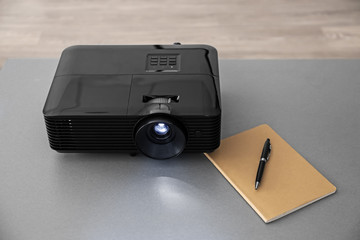 Video projector on table in conference hall
