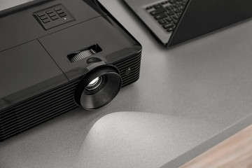 Video projector on table in conference hall