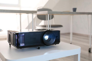 Video projector on table in conference hall