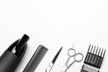 A set of tools for hairdresser, hairdryer, scissors, comb, on white background, top view, a copy of the space