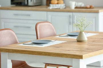 Stylish vase with floral decor in interior of kitchen