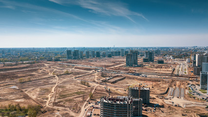 Aerial panoramic view of the construction of residential houses in the microdistricts. Space for text. Cityscape concept.