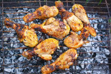 grilled chicken legs on the grill top view
