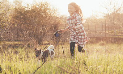 girl playing with a dog in nature,girl playing with fox terrier