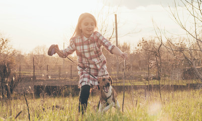 girl playing with a dog in nature,girl playing with fox terrier