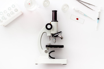 Laboratory examination with microscope. Equipment on white background top view