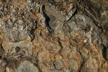Textured stone texture with hard light, for design. Orange rock.