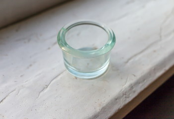 Vintage glass clear jar closeup on white painted Board