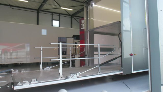 Trailer tailgate going up, Empty cargo truck loading door closing, wide