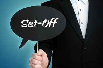 Set-Off. Lawyer in suit holds speech bubble at camera. The term Set-Off is in the sign. Symbol for law, justice, judgement