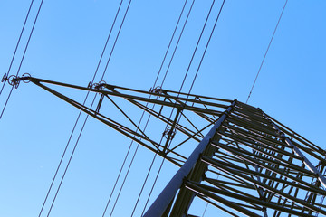 electricity pylons from low angle with blue sky