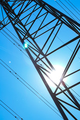 electricity pylons from low angle with blue sky