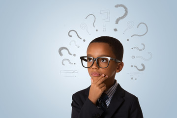 Handsome african american little boy wearing glasses and thinking with many question marks over blue background. Concept of ideas, confusion and solution