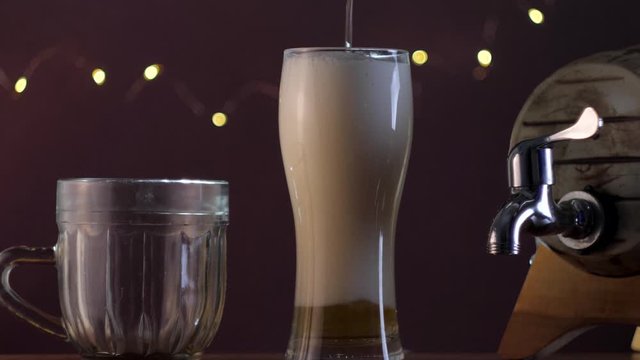 Pouring beer into the glass with lots of foam