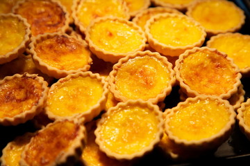 tart egg custard baked crispy sweet dessert .