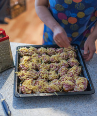 Prepared for baking in the oven sandwiches with sausage and cheese
