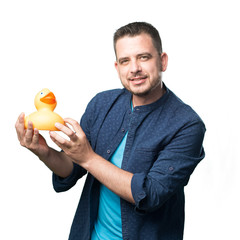 Young man wearing a blue outfit. Holding a toy duck.