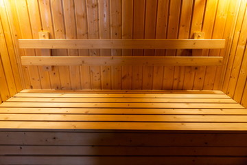 wooden bench and wall in sauna baked room , interior