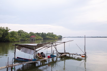 fisherman boat on river at countryside wooden port .