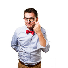 Man wearing a red bow tie. Pointing to his eye.