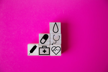 wood cube with a medical symbol  angle Flat lay,Concept: Health insurance family covid-2019 epidemic,
