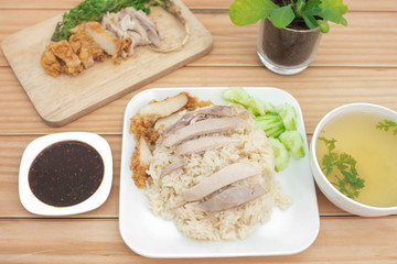 Chicken rice on the table, brown wood background.