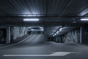 Sci fi looking dark and moody underground parking lot with fluorescent lights on. Up and down...