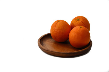 Oranges on a wooden plate