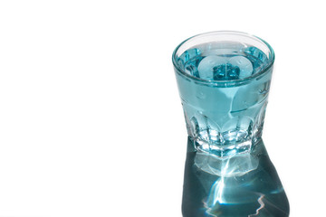glass with blue water, bright shadow. Refreshing drink.