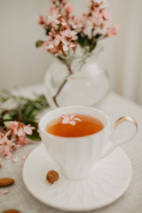 Obraz na płótnie Canvas White tea cup with flower