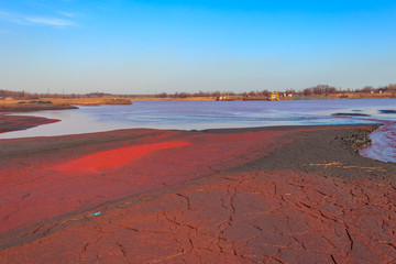 Technical settler of industrial water of mining industry with red soil polluted with iron ore waste in Kryvyi Rih, Ukraine