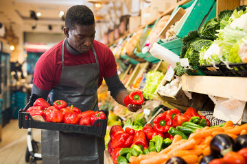 Salesman holding box with red peppers