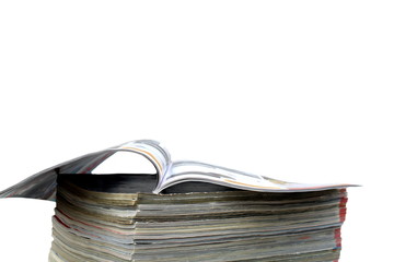 Background a stack of open glossy magazines, press