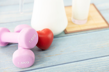 Glass milk and dumbbells for sport or exercise, good health concept. .