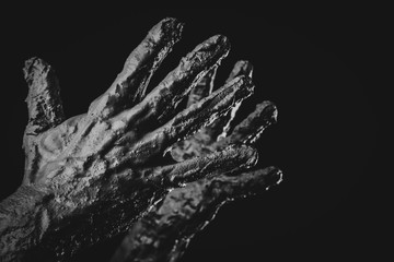 man's hands in dried clay