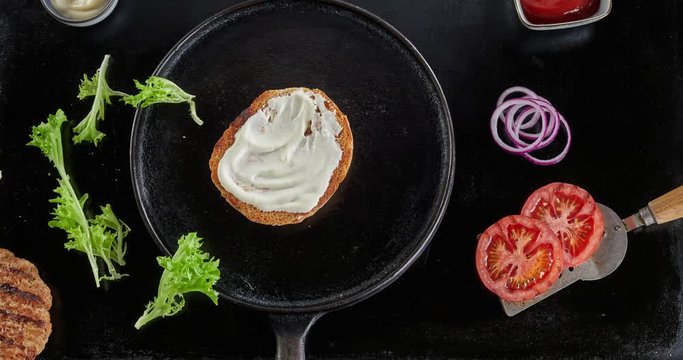 Prepare a burger for restaurant in flat lay style with grilled patties on black dark background, Food concept for advertising and cooking schools.